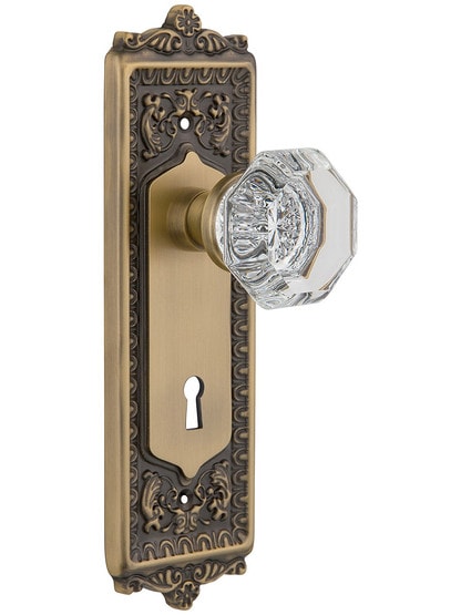 Egg and Dart Style Mortise Lock Set with Waldorf Crystal Door Knobs in Antique Brass.